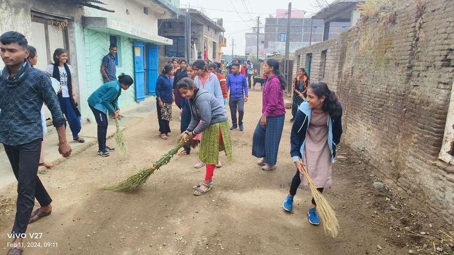 Students sweeping village streets — community sanitation drive