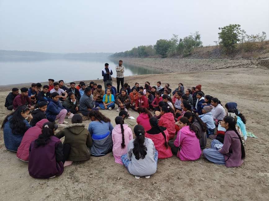 Outdoor group discussion circle by a lake